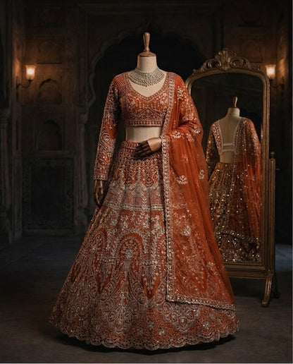 Rust Orange Heavily Embroidered Silk Lehenga Choli Set with Backless Tassel Detail and Intricate Silver Zari Work
