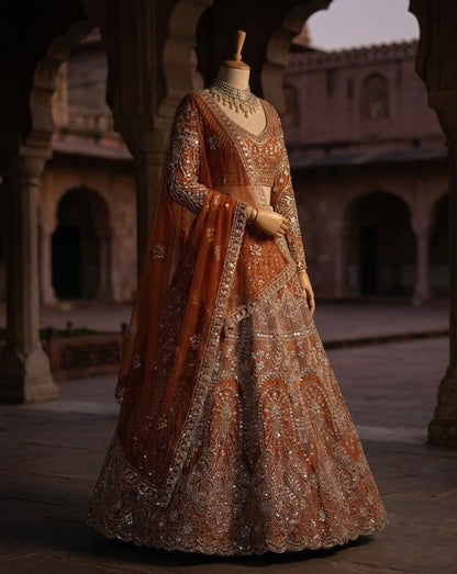 Rust Orange Heavily Embroidered Silk Lehenga Choli Set with Backless Tassel Detail and Intricate Silver Zari Work