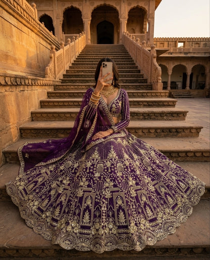 Royal Purple Heavily Embroidered Silk Lehenga Choli Set with Intricate Golden Zari Panels and Sheer Dupatta