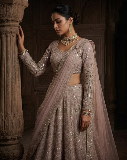 Muted Mauve Heavily Embellished Net Lehenga Choli Set with Full Sleeves and Intricate Sequin Zari Border
