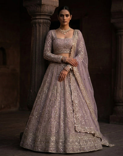 Muted Mauve Heavily Embellished Net Lehenga Choli Set with Full Sleeves and Intricate Sequin Zari Border