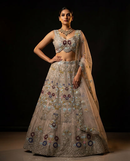 Elegant Pastel Beige Embroidered Net Lehenga Choli Set with Muted Floral Highlights and Sheer Dupatta