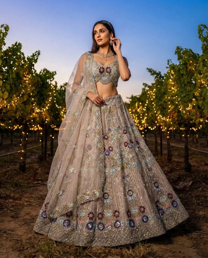 Elegant Pastel Beige Embroidered Net Lehenga Choli Set with Muted Floral Highlights and Sheer Dupatta